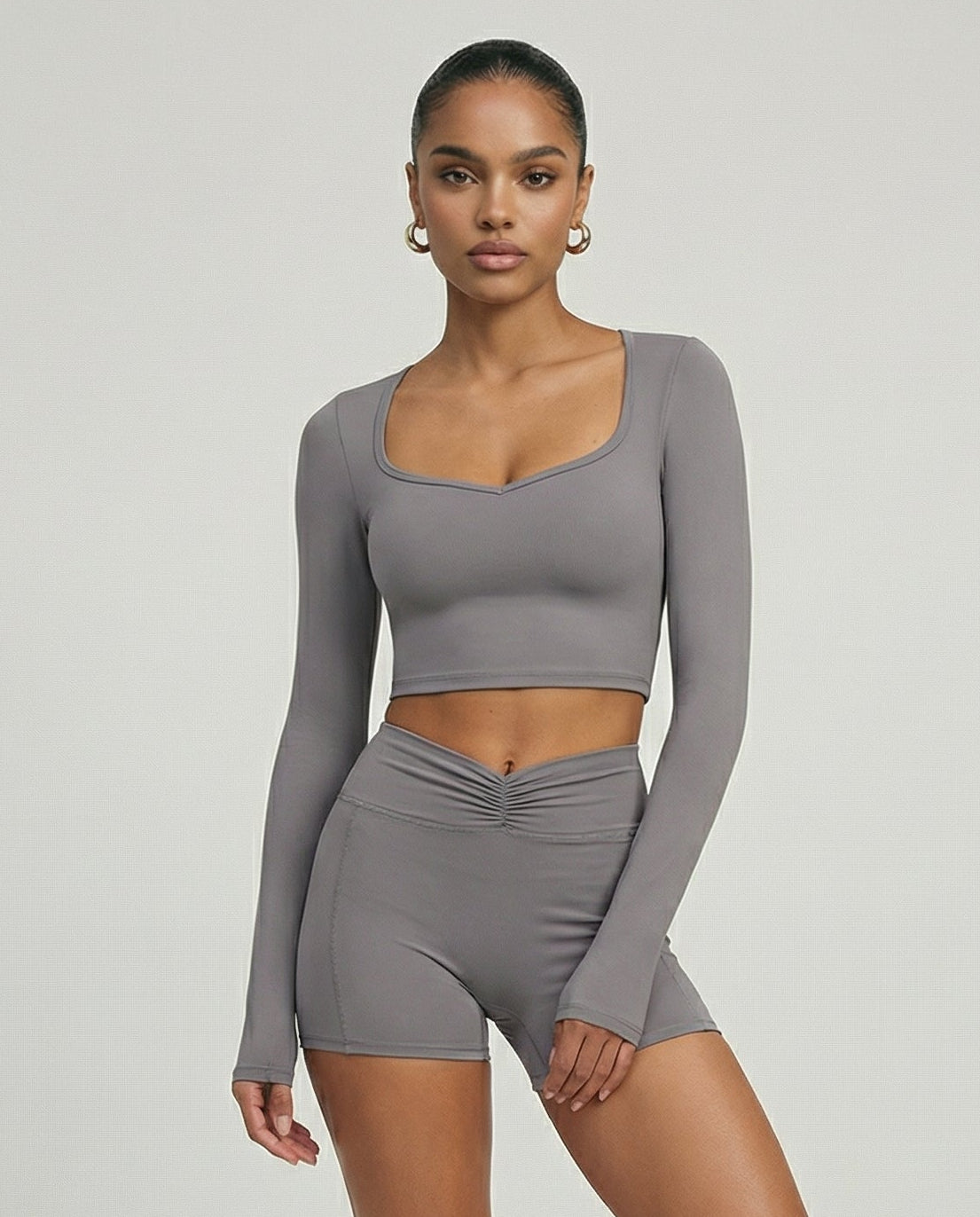 Seen women's activewear set with sculpting biker shorts and long sleeve top, designed for workout and active wear.