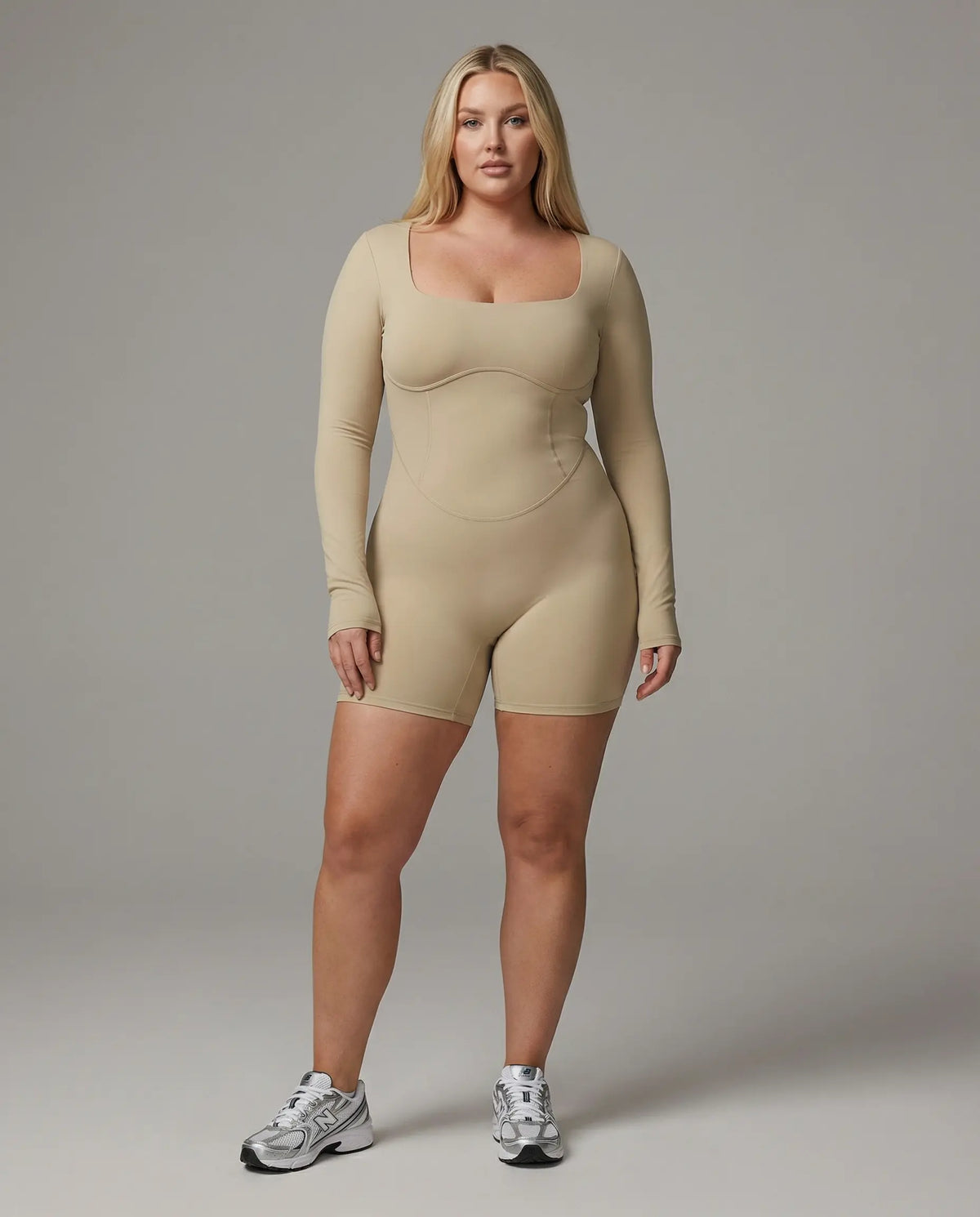 Woman wearing a long sleeve compression shorts sculpting romper designed for activewear and athleisure use.