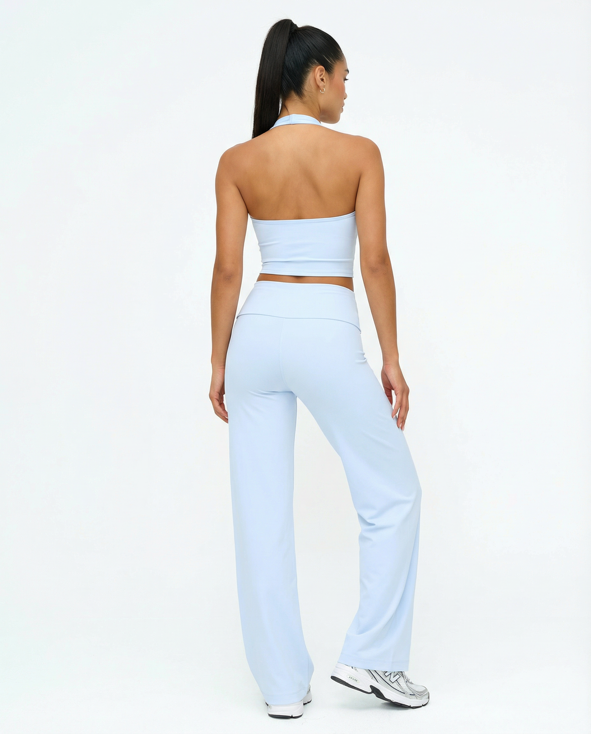 Seen flare yoga pants set with high waist and halter sports bra, featuring a comfortable and stylish athletic wear design.