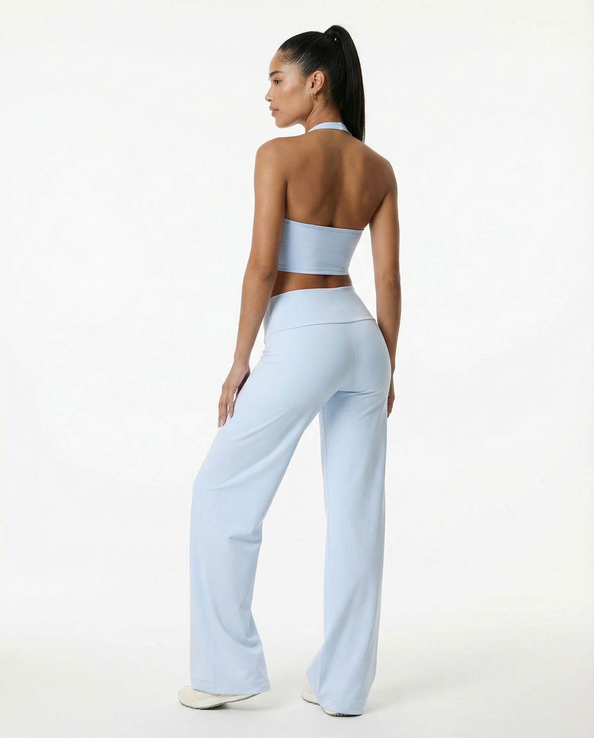 Seen flare yoga pants set with high waist and halter sports bra, featuring a stylish and comfortable activewear look.