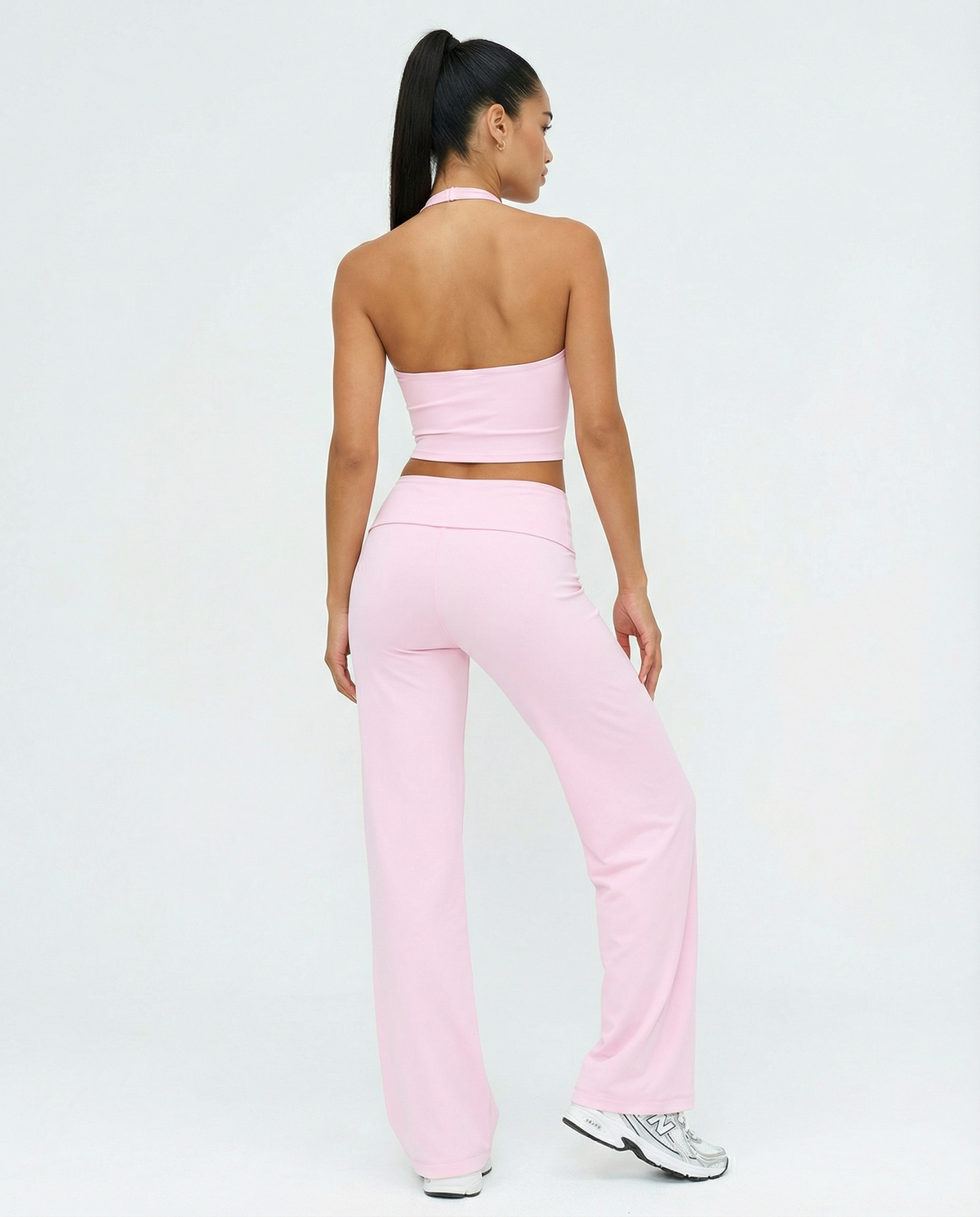 Seen flare yoga pants set with high waist and halter sports bra, featuring a stylish, comfortable activewear look.