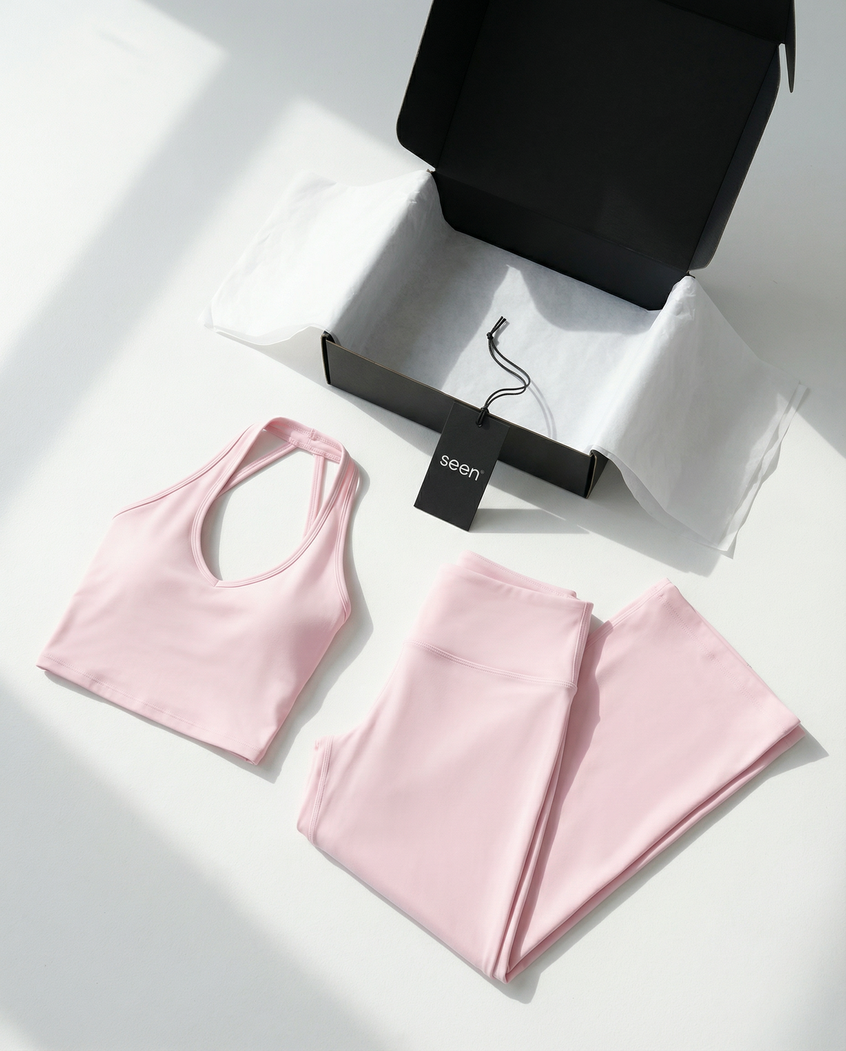 Seen flare yoga pants set with high waist and halter sports bra, shown in black with flare leg design and supportive fit.