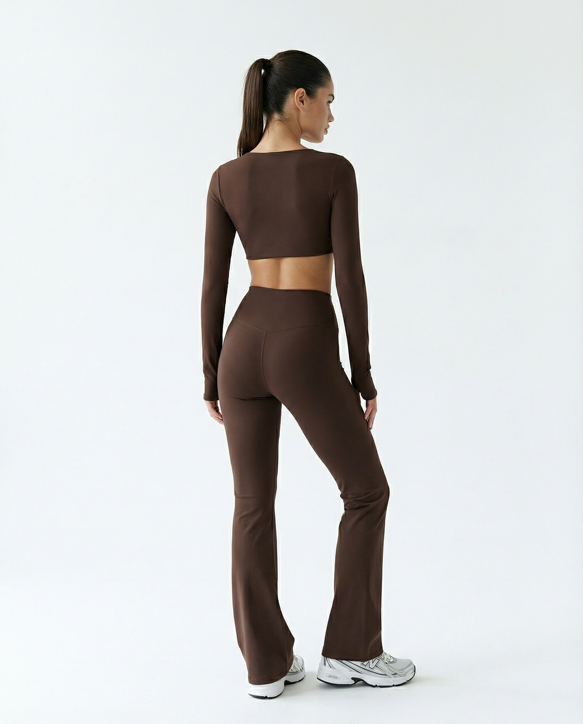 Seen flare yoga pants set featuring high waist and long sleeve crop top, shown in a stylish, comfortable athletic wear design.