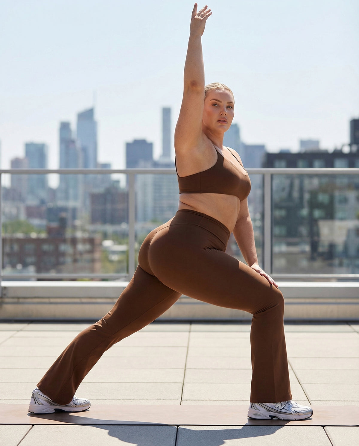 Seen women's flare yoga pants set with high waist leggings and matching sports bra, shown on a model in a workout pose.