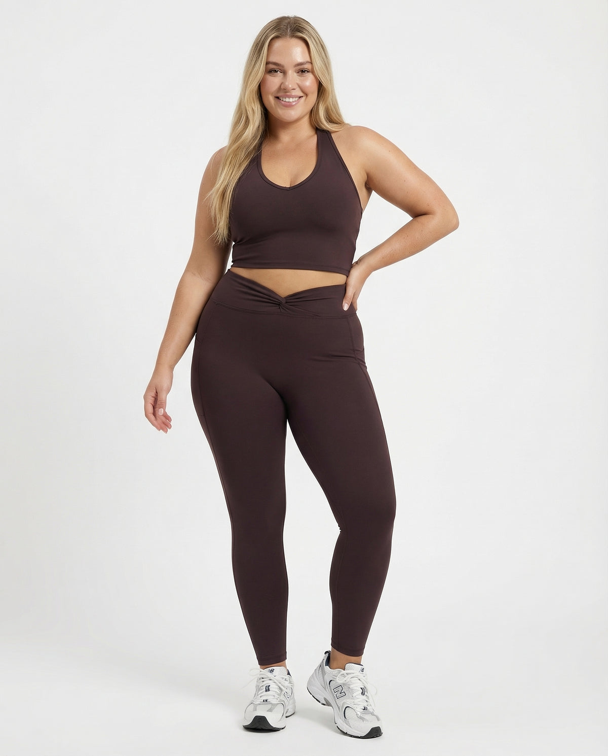 Seen women's high waist leggings set with sculpting fit and matching halter top, shown on a model in a fitness pose.