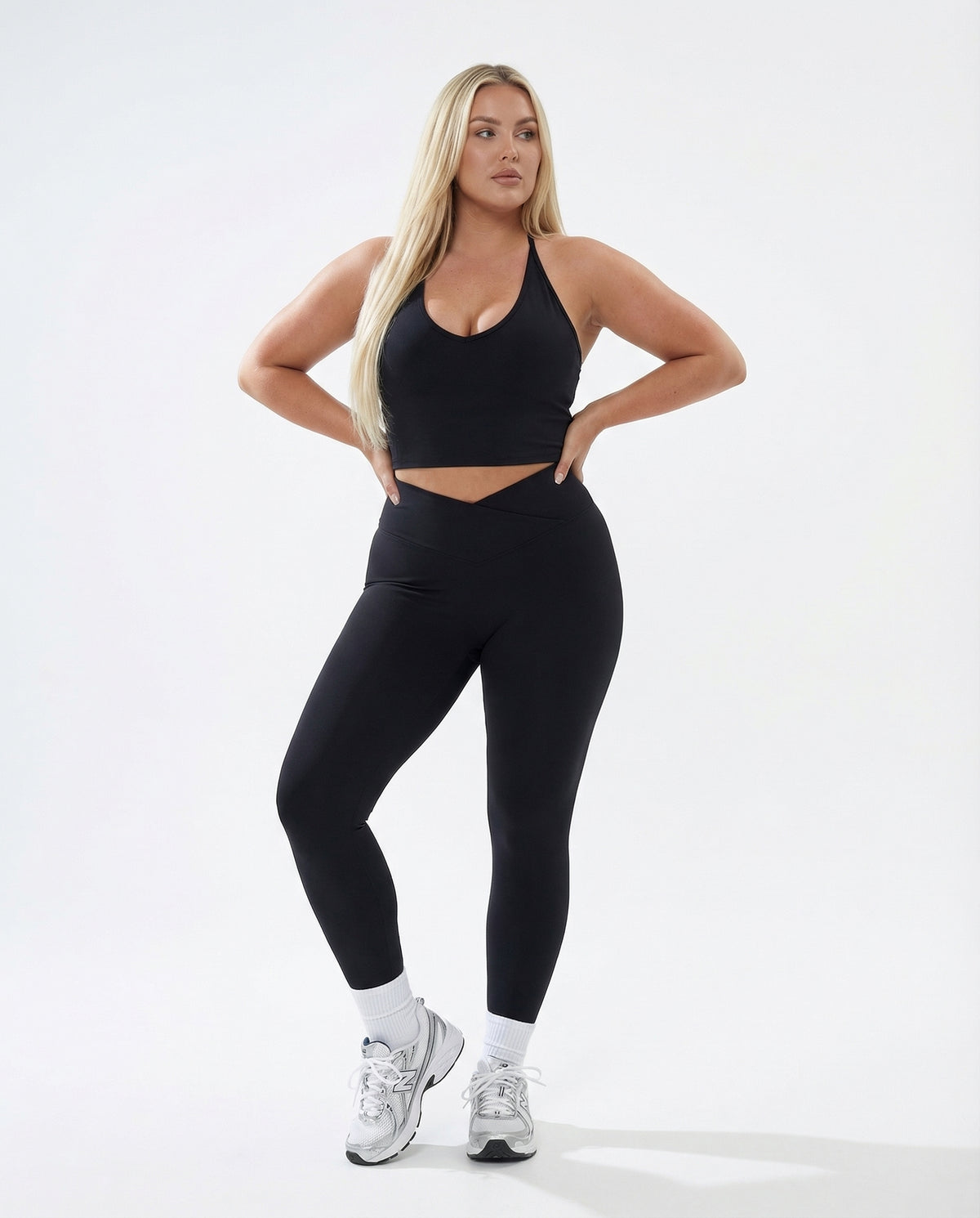 Seen high waist leggings set with sculpting fit and matching halter top, designed for women's activewear, shown on a model.