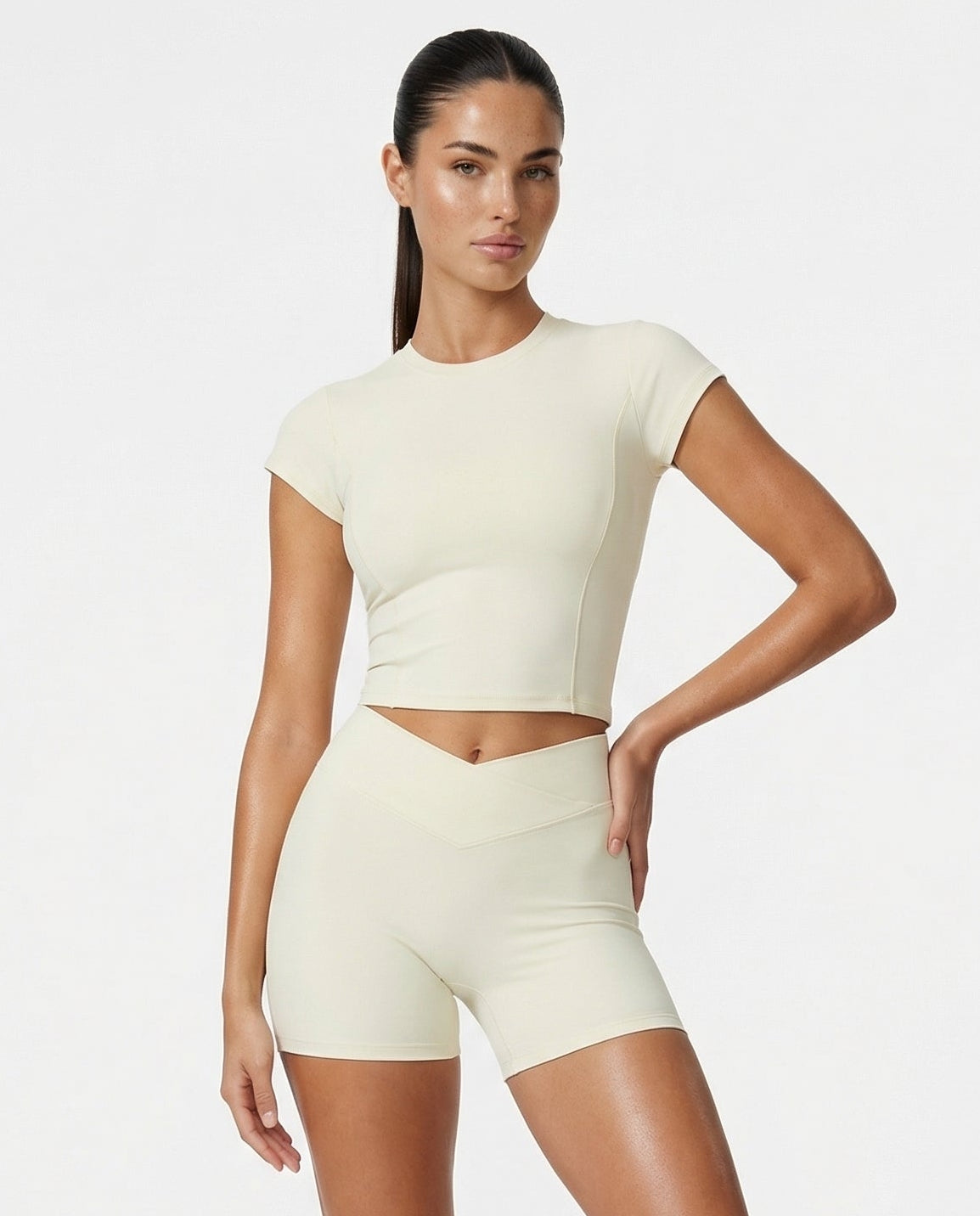 Seen women's SculptFit beige crop top and shorts activewear set displayed on a model. Comfortable, stylish athletic outfit.