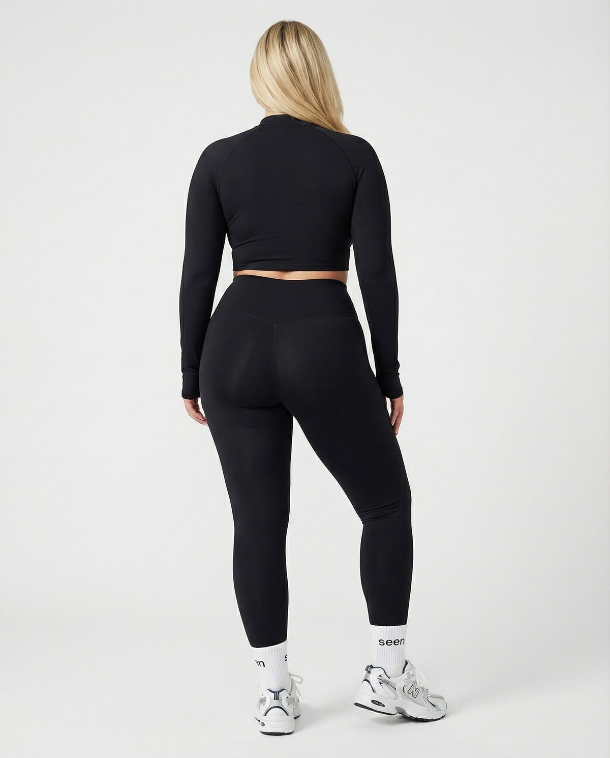 Seen women's activewear set with long sleeve top and high waist leggings, shown in a matching athletic outfit.
