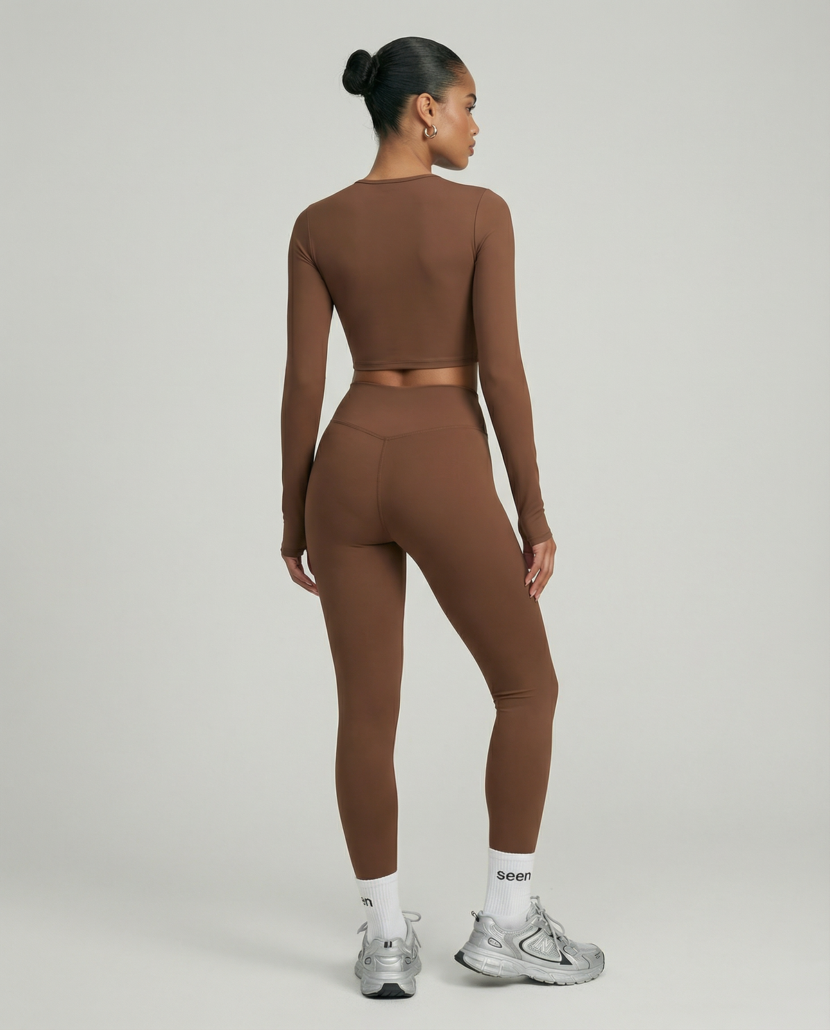 Seen women's activewear set featuring long sleeve top and high waist leggings, in breathable, stretchy fabric for workout comfort.