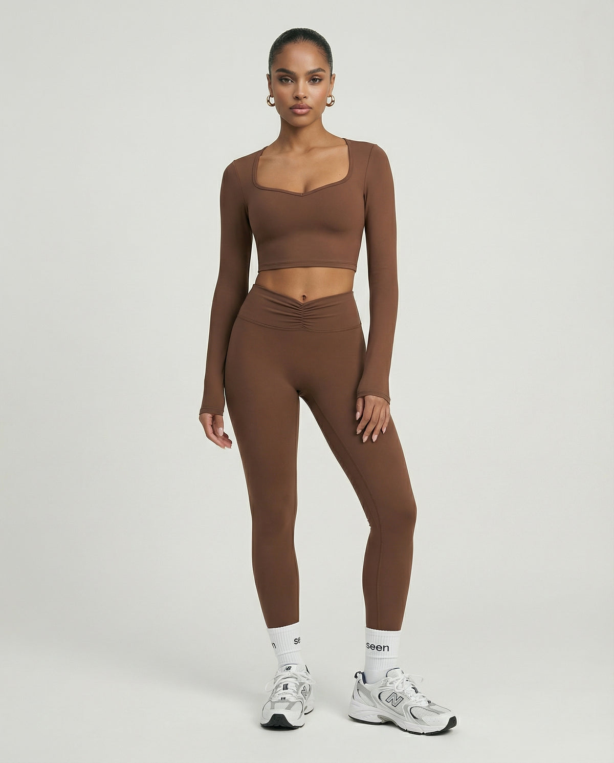 Seen women's activewear set featuring long sleeve top and high waist leggings, in a stylish athletic workout outfit.