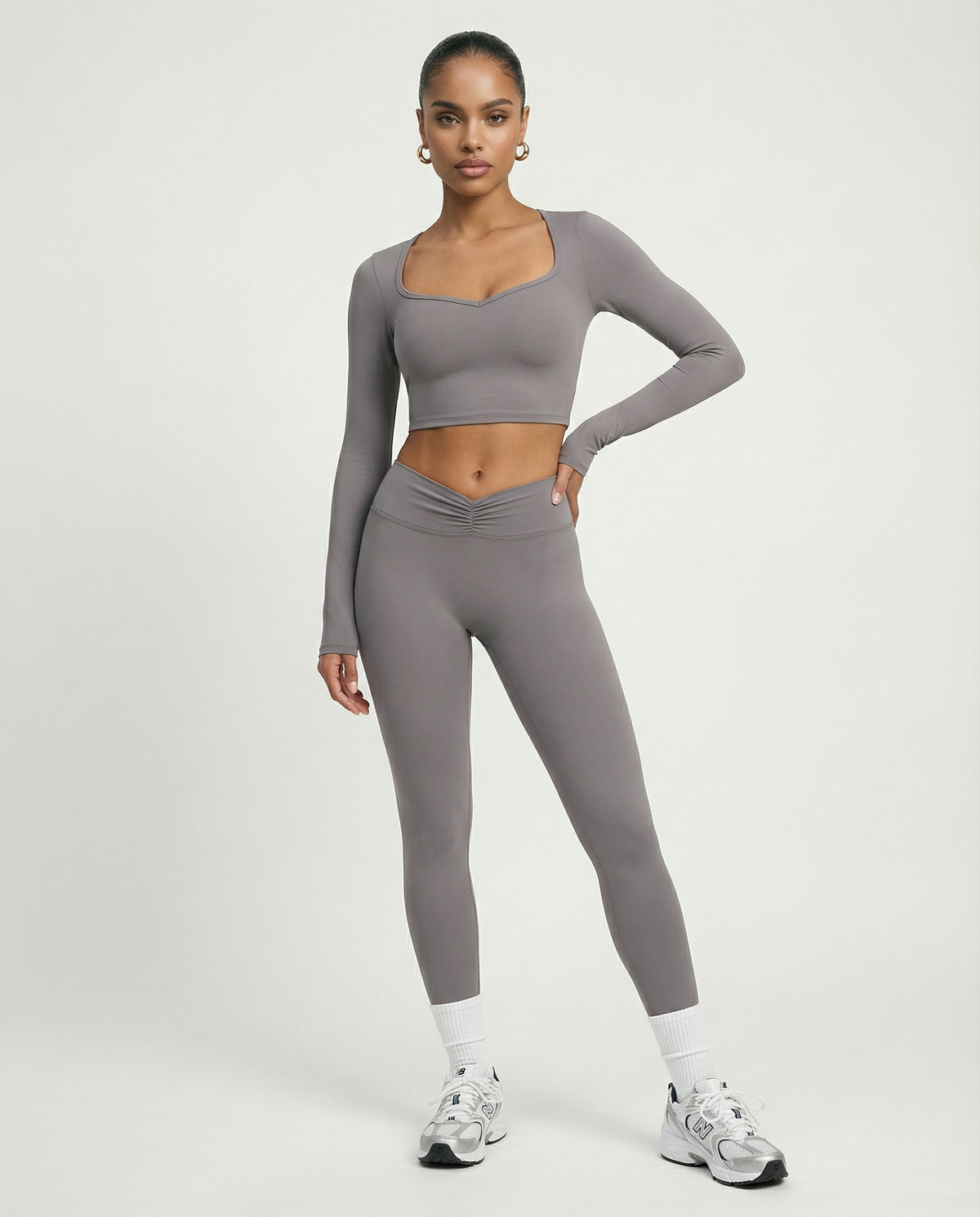 Seen women's activewear set featuring long sleeve top and high waist leggings in a stylish, form-fitting design.