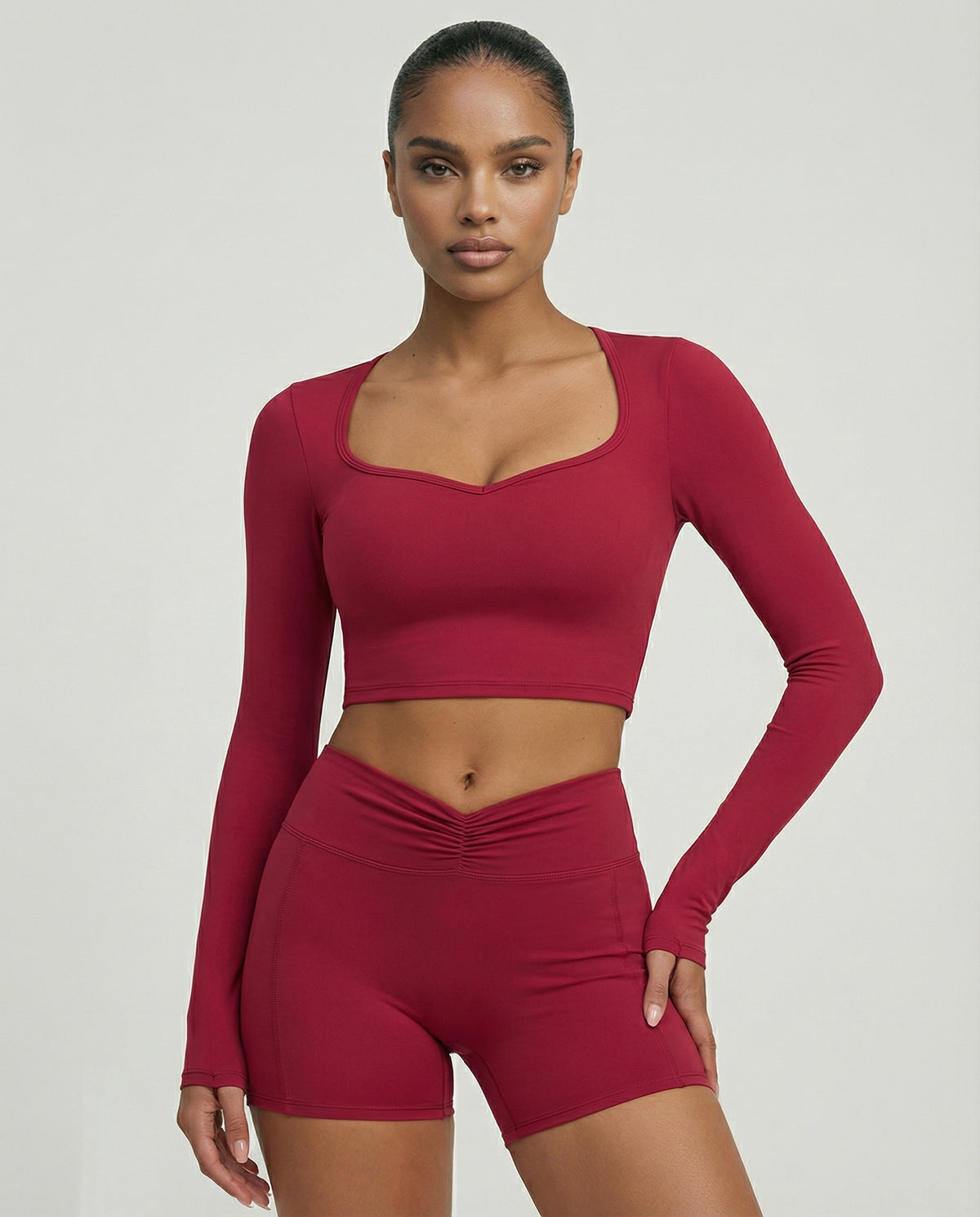 Seen women's activewear set with black biker shorts and long sleeve top, designed for sculpting and workout comfort.