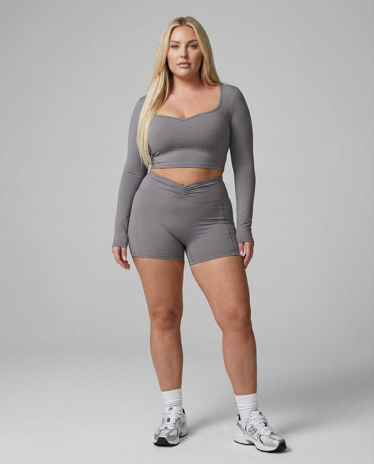 Seen women's activewear set with black sculpting biker shorts and long sleeve top, designed for workout and athleisure wear.