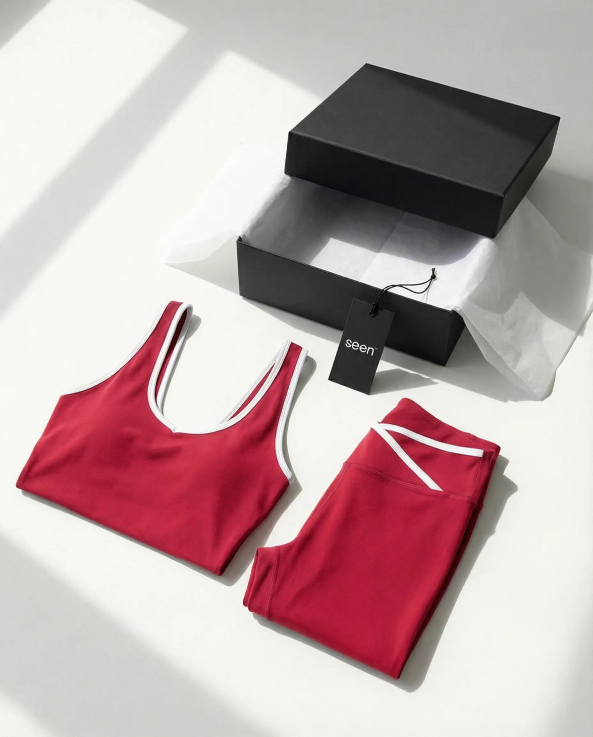 Woman wearing seamless sculpt high waist gym set with tank top and leggings in red, shown from front and back.