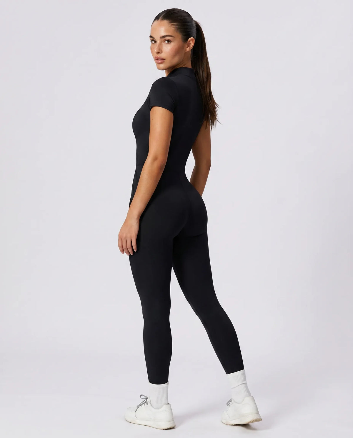 Ghost mannequin back view of brown short sleeve jumpsuit legging highlighting seamless back panel and ankle-length fit.