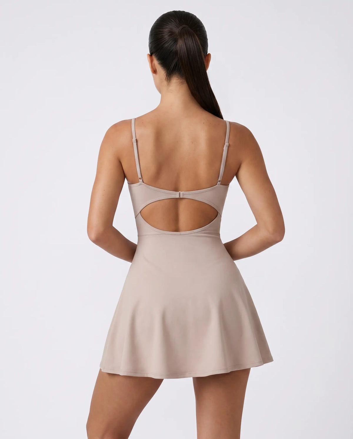 Women's grey padel dress with thin straps and A-line skirt displayed on ghost mannequin, front view.