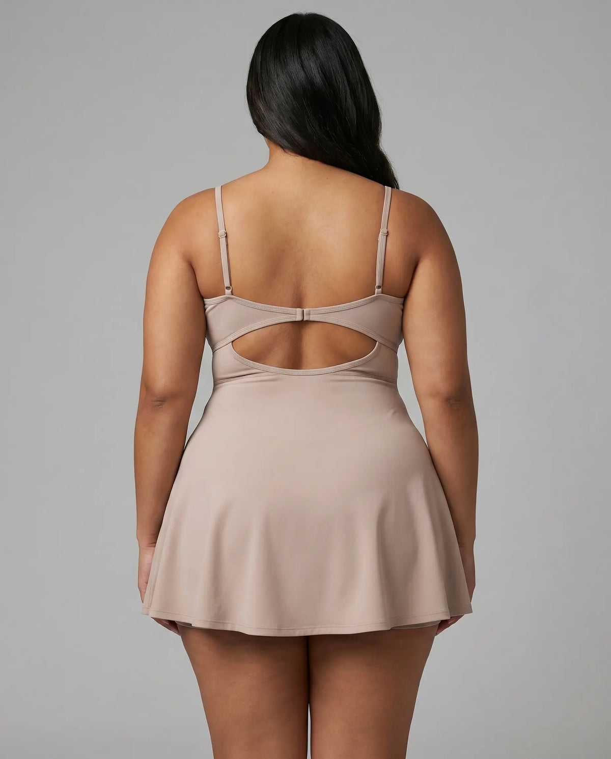 Women's grey padel dress with thin straps and A-line skirt displayed on ghost mannequin, front view.