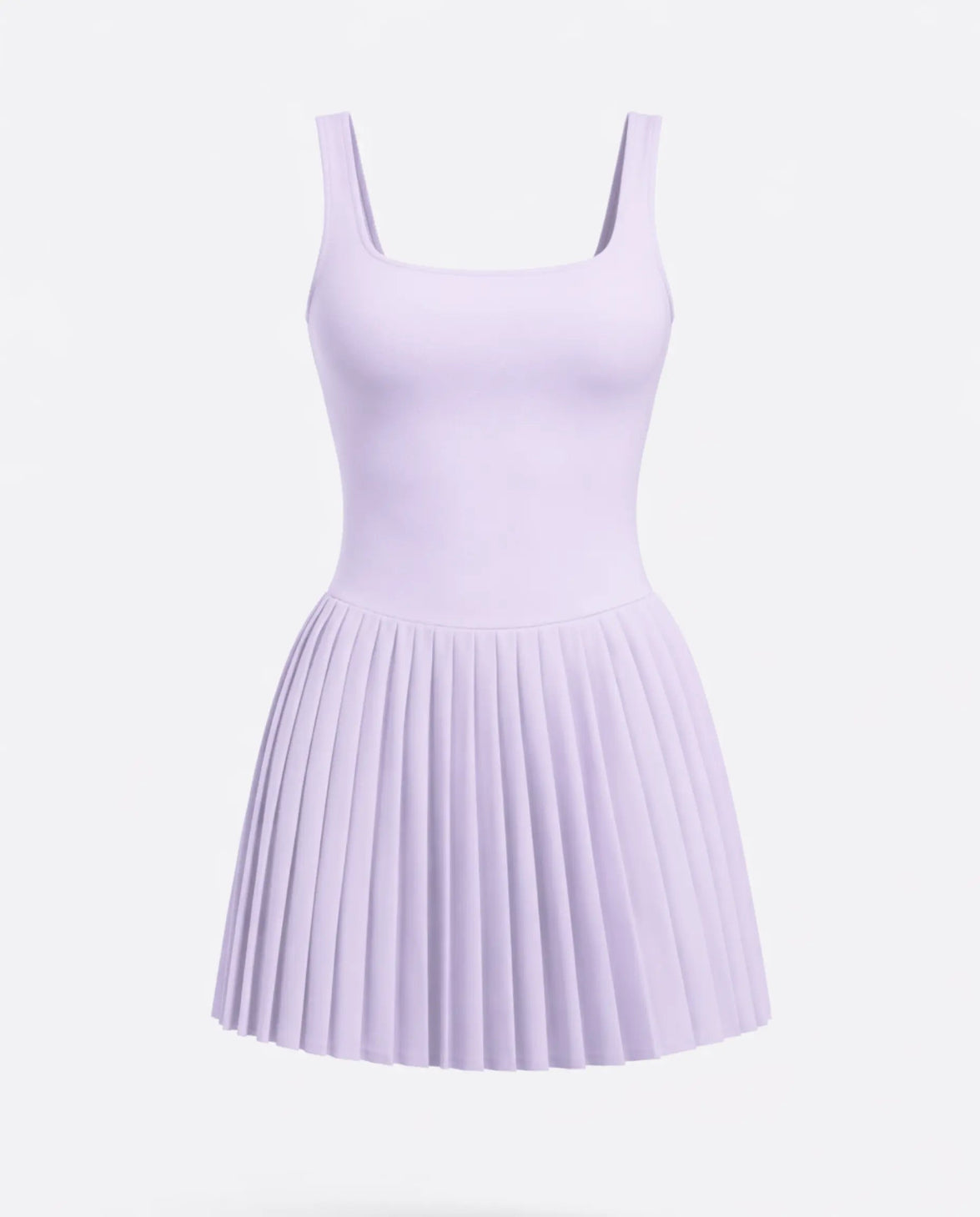Lifestyle shot of woman in the SEEN Essential purple pleated tennis dress mid-movement highlighting skirt flow and active versatility.