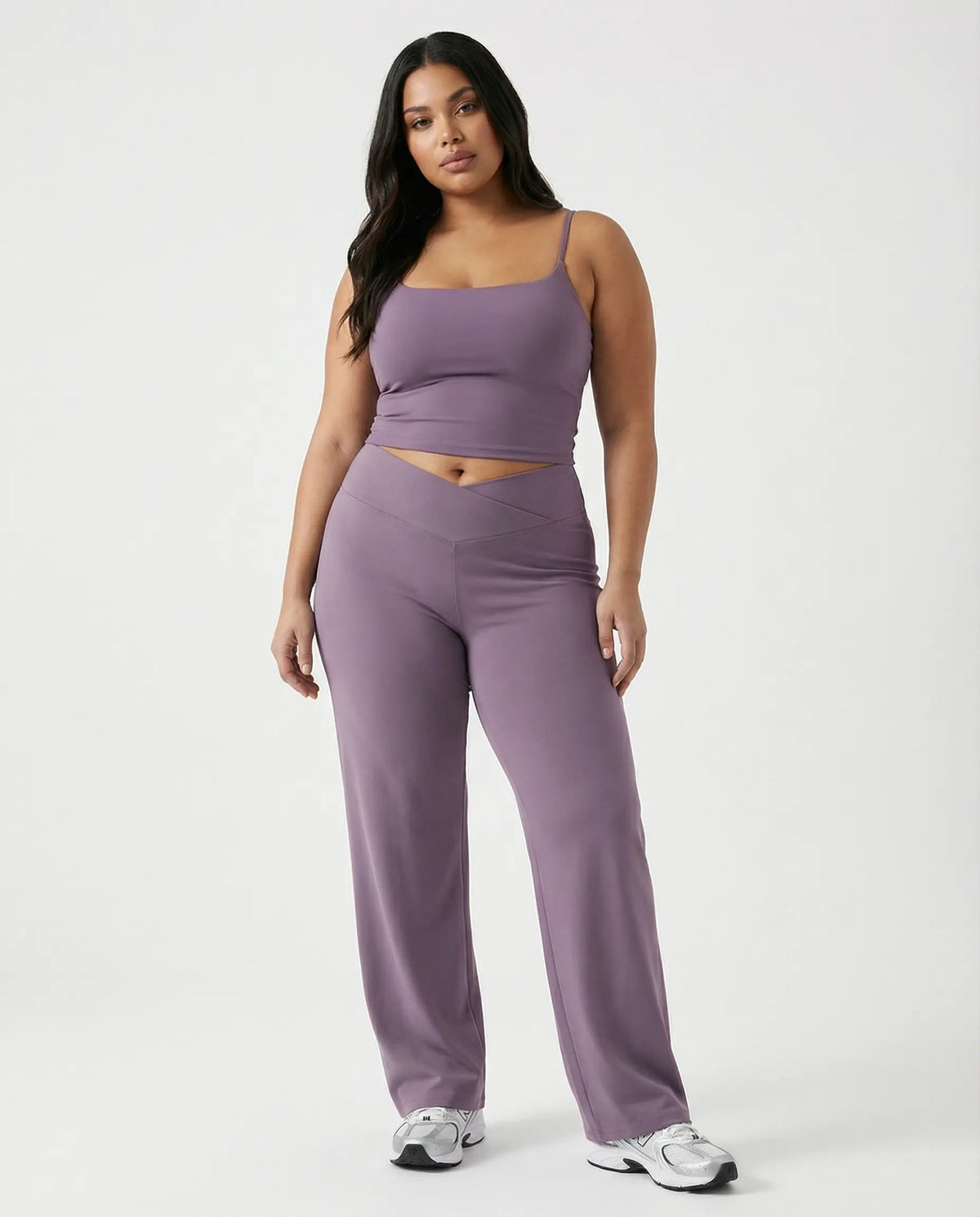 Curvy model wearing mauve high waist crossover wide leg leggings with matching tank top, front view showing V-panel waistband.