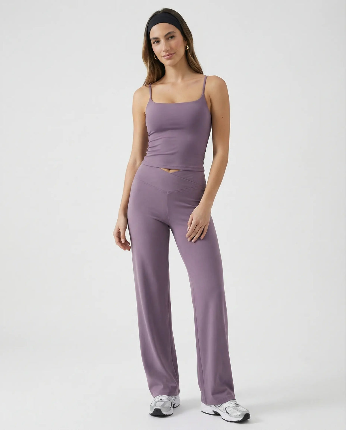 Model wearing mauve high waist crossover wide leg leggings with matching tank top, front view showing sculpting crossover waistband.