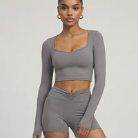 Seen women's activewear set with sculpting biker shorts and long sleeve top, designed for workout and active wear.