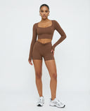 Seen women's activewear set with sculpting brown biker shorts and long sleeve top, designed for workout and active wear.