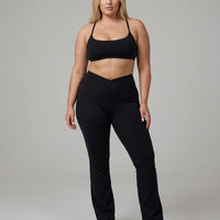 Black women's activewear set with flare leggings and matching sports bra from seen, designed for yoga and sculpt fit workouts.