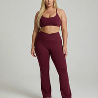 Seen women's activewear set with red flare leggings and matching sculpt fit sports bra, designed for yoga and workouts.