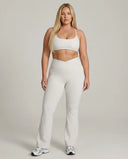 Seen women's activewear set with white flare leggings and matching sports bra, designed for yoga and sculpt fit fitness.