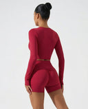 Seen women's activewear set with sculpting biker shorts and long sleeve top, shown from the back view.