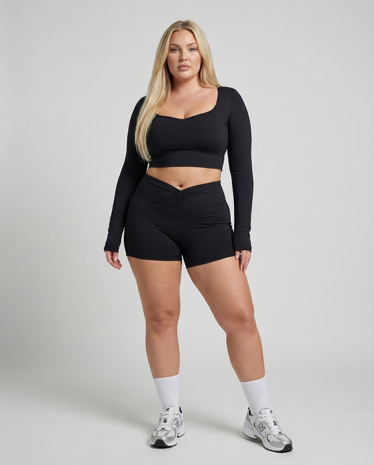 Seen women's activewear set with black sculpting biker shorts and long sleeve top, designed for comfortable workouts.