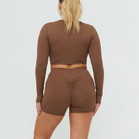 Seen women's activewear set with brown sculpting biker shorts and long sleeve top, designed for comfort and support.