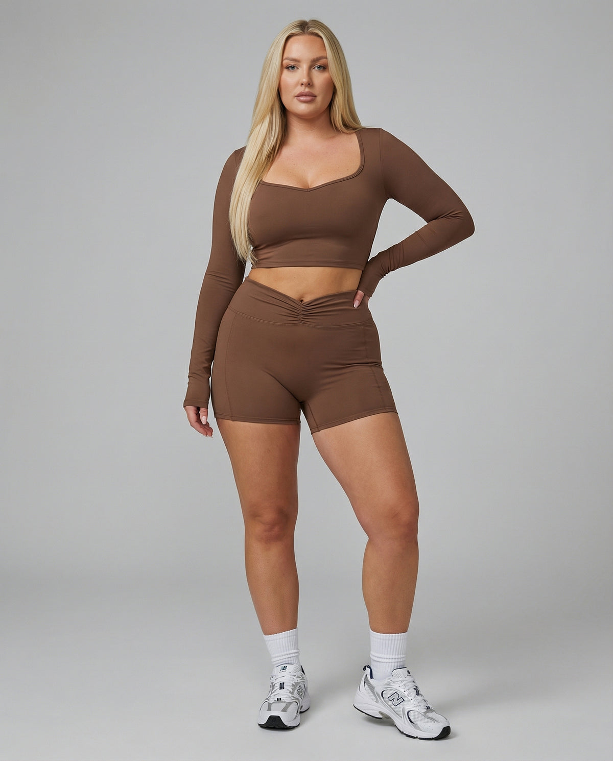 Seen women's activewear set with sculpting brown biker shorts and long sleeve top, perfect for workout and casual wear.