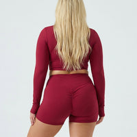 Seen women's activewear set with red sculpting biker shorts and long sleeve top, designed for comfort and movement.