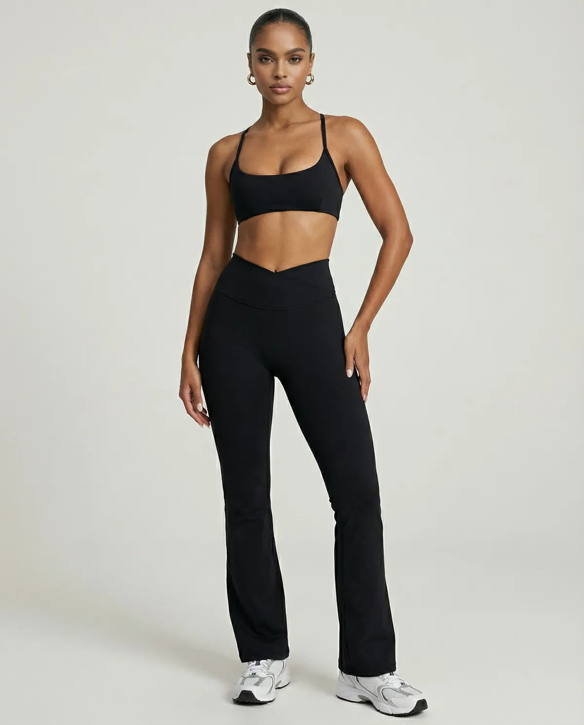 Seen women's activewear set with black yoga flare leggings and matching sculpt fit sports bra, front view.