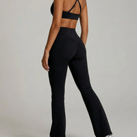 Seen women's activewear set with black flare leggings and matching sports bra, shown from the back for yoga and fitness.