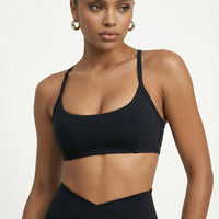 Black women's activewear set featuring flare leggings and a sculpt fit sports bra from seen, ideal for yoga and workouts.