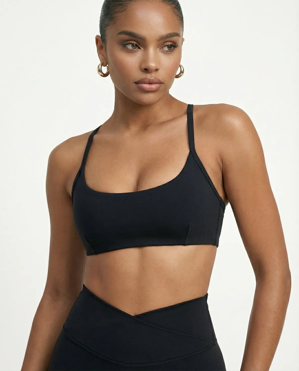 Black women's activewear set featuring flare leggings and a sculpt fit sports bra from seen, ideal for yoga and workouts.