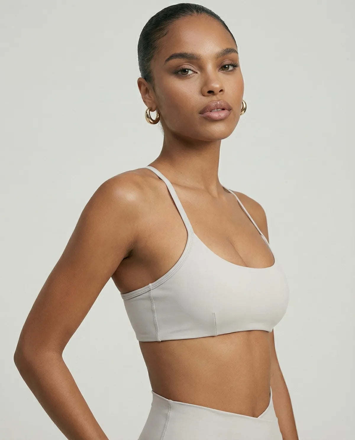 Women's white activewear set with flare leggings and matching sculpt fit sports bra, ideal for yoga and fitness activities.