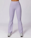 Front view of flare high waist sculpt yoga leggings in lavender purple, featuring a wide sculpting waistband and full-length flare leg, paired with silver sneakers.