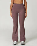 Front view of flare high waist sculpt yoga leggings in mauve, showing the wide sculpting waistband and leg-lengthening flare silhouette paired with white sneakers.