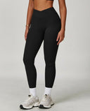 Front view of black high waist crossover V-waistband sculpting compression leggings paired with white sneakers, showing the smooth squat-proof fit and sculpting silhouette.