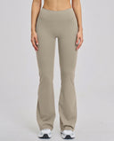 Front view of flare high waist sculpt yoga leggings in mocha featuring a wide waistband and lengthening flare leg silhouette paired with white sneakers.