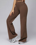 Brown flare high waist sculpting yoga leggings with wide waistband and front seam detail, paired with white sneakers on a grey background.
