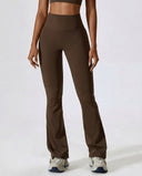 Front view of brown flare high waist sculpting yoga leggings with wide waistband and bootcut silhouette paired with sneakers.