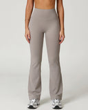 Front view of grey flare high waist sculpting leggings with wide waistband and bootcut leg, paired with white sneakers.