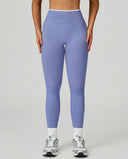 Front view of seamless high waist sculpting compression leggings in light blue, showing smooth waistband and full-length silhouette paired with white sneakers.