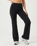 Front view of black high waist flare leggings with sculpting compression fit and wide waistband, paired with sneakers.
