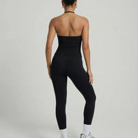 Model wearing a black seamless halter sculpt leggings set with high waist fitted leggings and athletic sneakers.