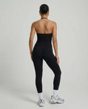 Model wearing a black seamless halter sculpt leggings set with high waist fitted leggings and athletic sneakers.